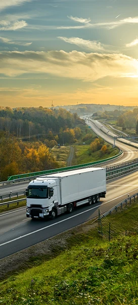 white truck travels along a highway